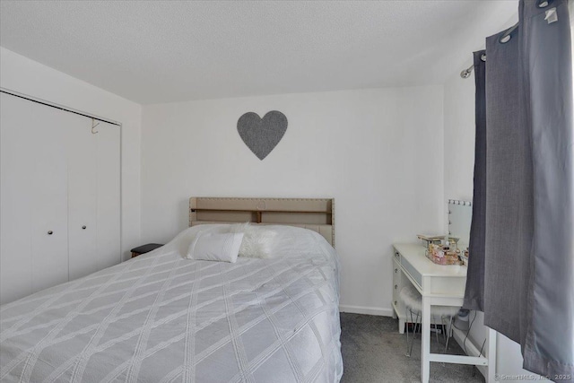 carpeted bedroom with a textured ceiling and a closet