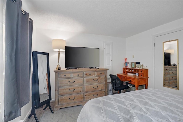 carpeted bedroom featuring a textured ceiling