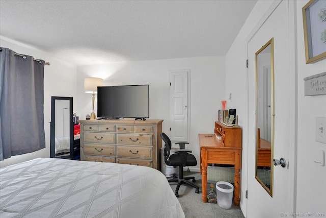 carpeted bedroom featuring a textured ceiling