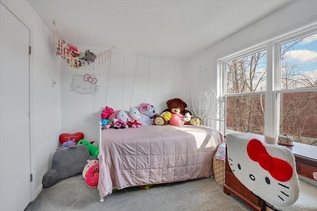 carpeted bedroom with a textured ceiling