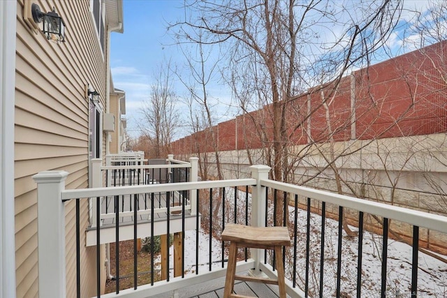 view of snow covered back of property