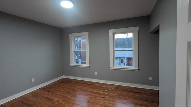 unfurnished room featuring dark wood-type flooring