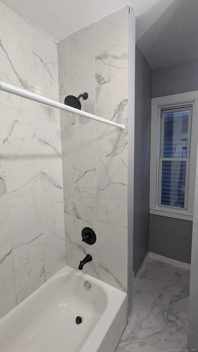 bathroom featuring tiled shower / bath