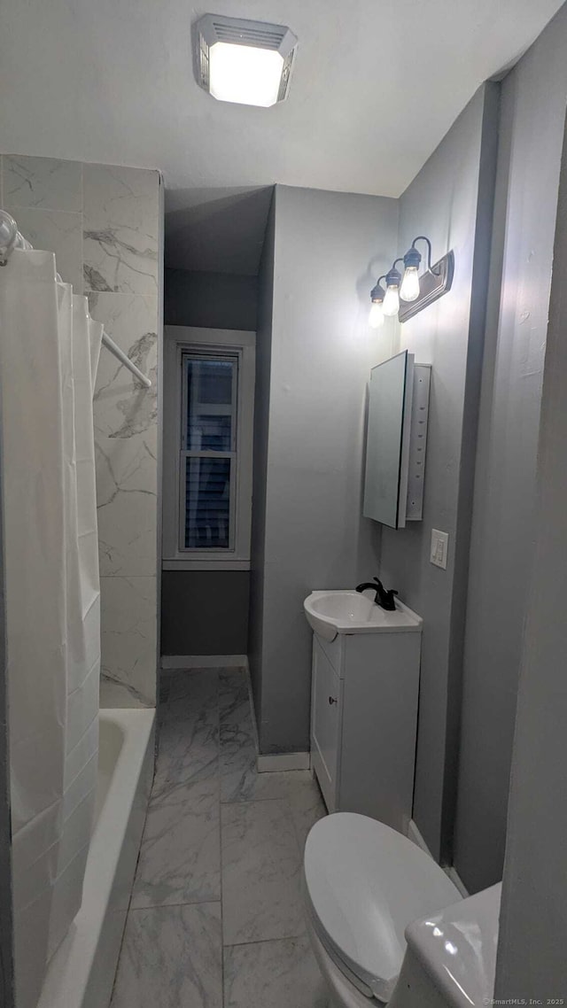 full bathroom with vanity, shower / tub combo, and toilet