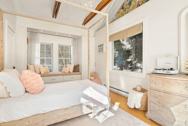 bedroom with multiple windows, a baseboard heating unit, vaulted ceiling, and light wood-type flooring