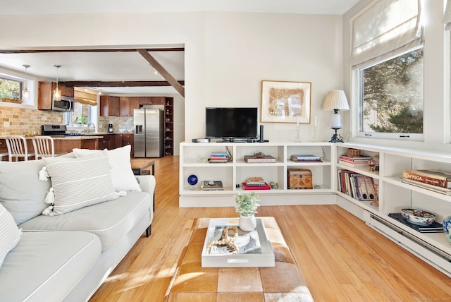 living room with sink and light wood-type flooring