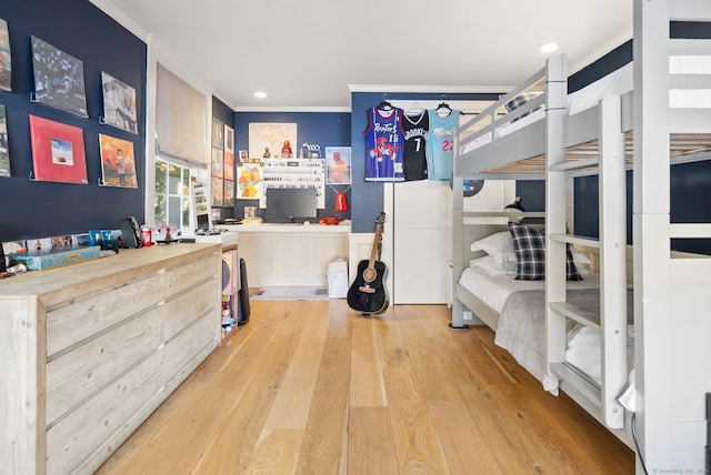 bedroom with crown molding and light hardwood / wood-style floors