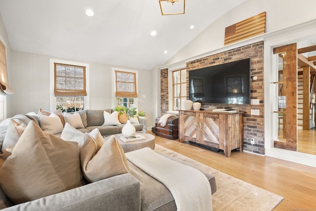 living room featuring hardwood / wood-style flooring and vaulted ceiling