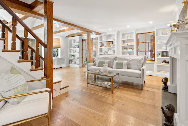 living room with built in features and light hardwood / wood-style floors