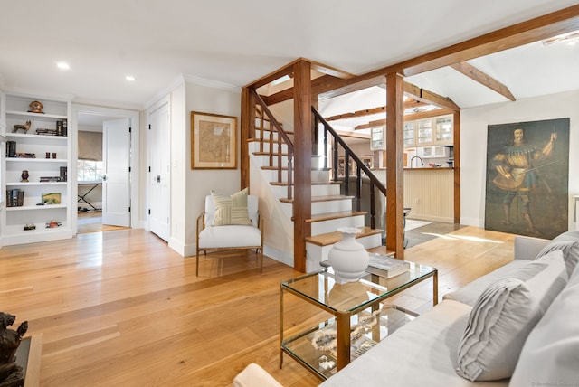 living room featuring ornamental molding and light wood-type flooring