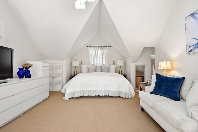 bedroom with vaulted ceiling and light carpet