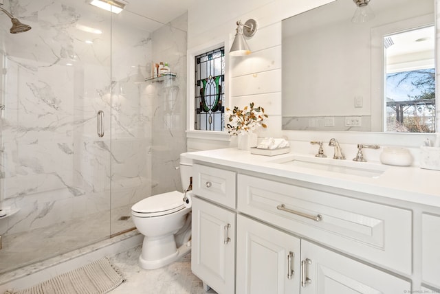 bathroom featuring vanity, toilet, and an enclosed shower