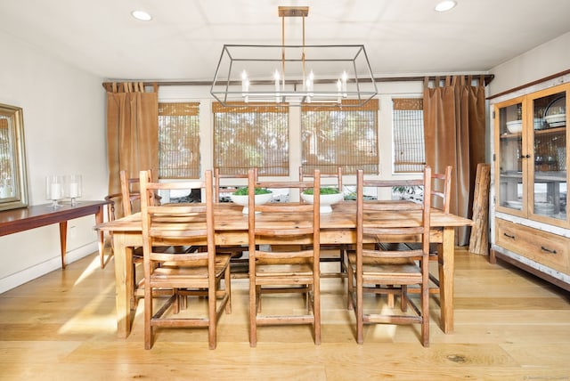 dining room with an inviting chandelier and light hardwood / wood-style flooring