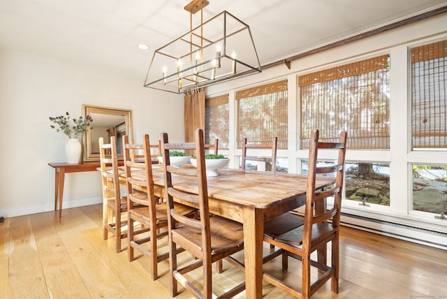 dining space with an inviting chandelier and light wood-type flooring