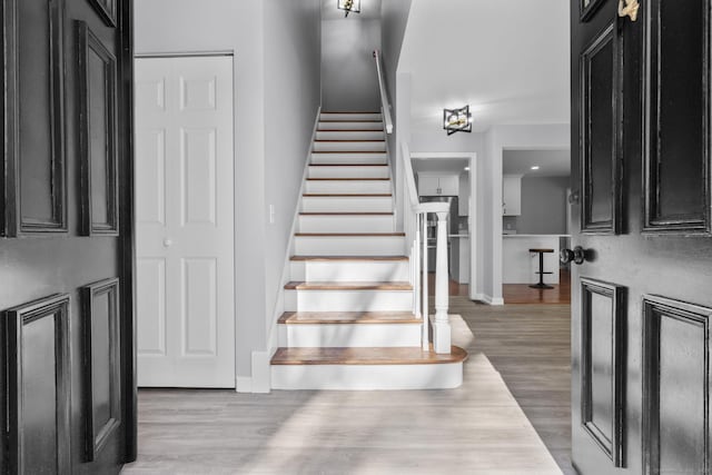 stairway featuring baseboards and wood finished floors