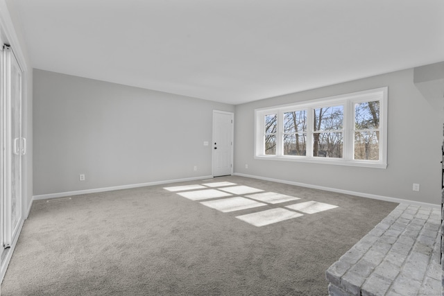 unfurnished room with baseboards and carpet flooring