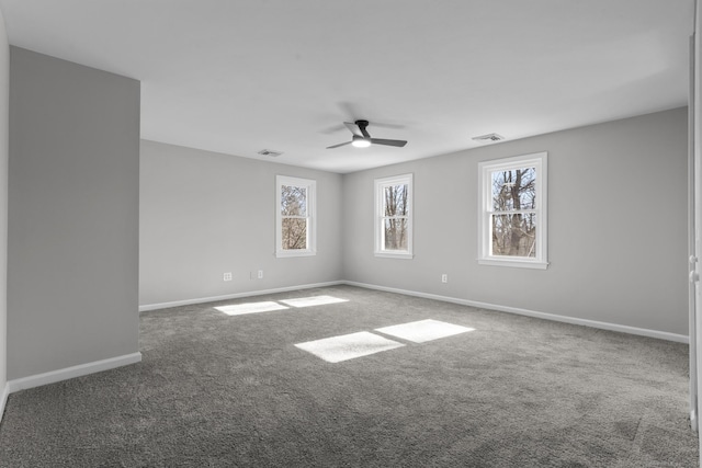 empty room featuring ceiling fan, carpet flooring, visible vents, and baseboards