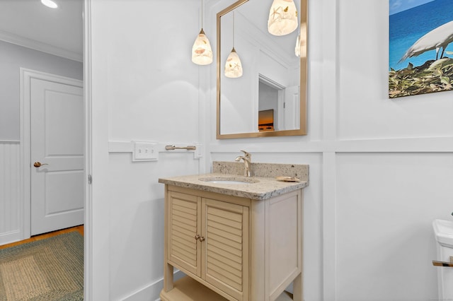 bathroom with vanity and ornamental molding