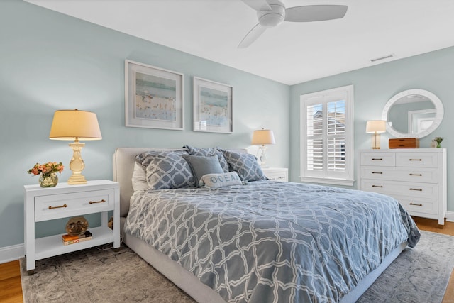 bedroom with wood-type flooring and ceiling fan