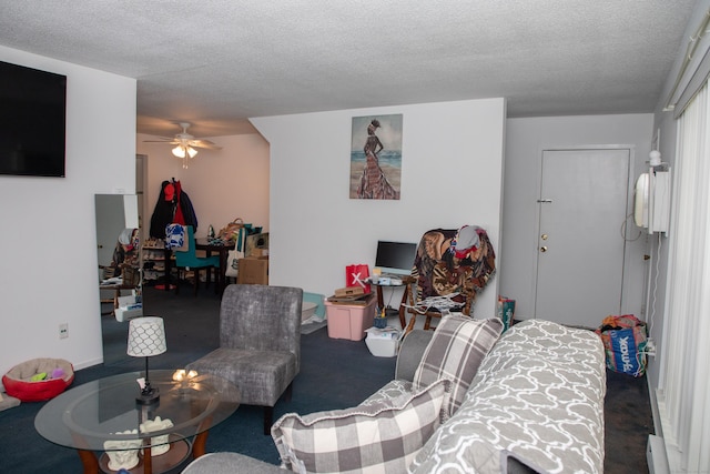 carpeted living room with ceiling fan and a textured ceiling