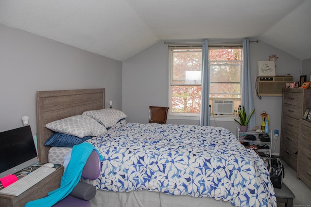 bedroom with cooling unit, vaulted ceiling, and an AC wall unit