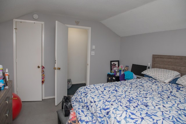 carpeted bedroom with lofted ceiling