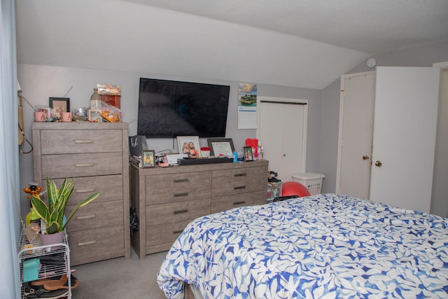 carpeted bedroom featuring lofted ceiling