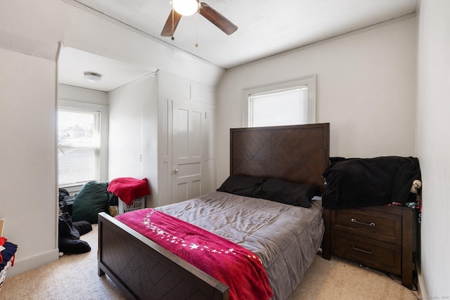 bedroom with light colored carpet and ceiling fan