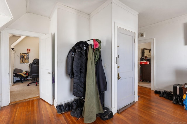 corridor with hardwood / wood-style floors and ornamental molding