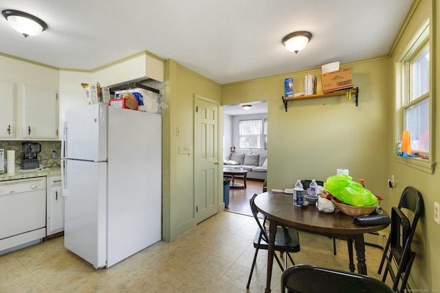 kitchen featuring white cabinetry, white appliances, and decorative backsplash