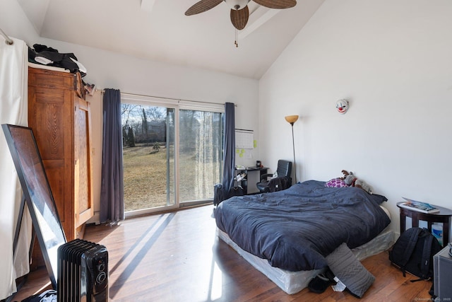 bedroom featuring hardwood / wood-style flooring, ceiling fan, and vaulted ceiling