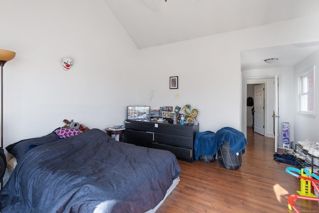 bedroom featuring lofted ceiling and dark hardwood / wood-style floors