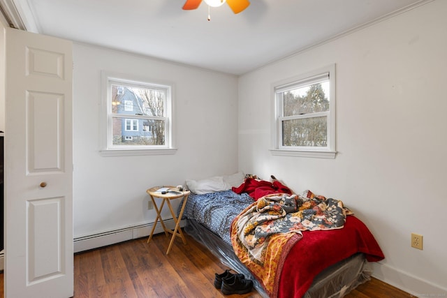 bedroom featuring ceiling fan, a baseboard radiator, and dark hardwood / wood-style flooring