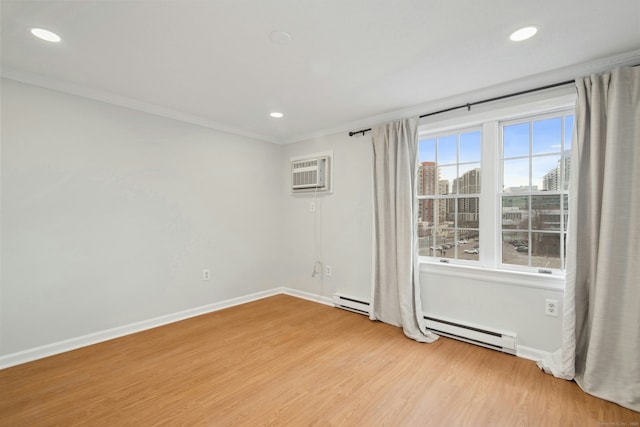 spare room with a wall mounted air conditioner, a baseboard radiator, ornamental molding, and light hardwood / wood-style flooring