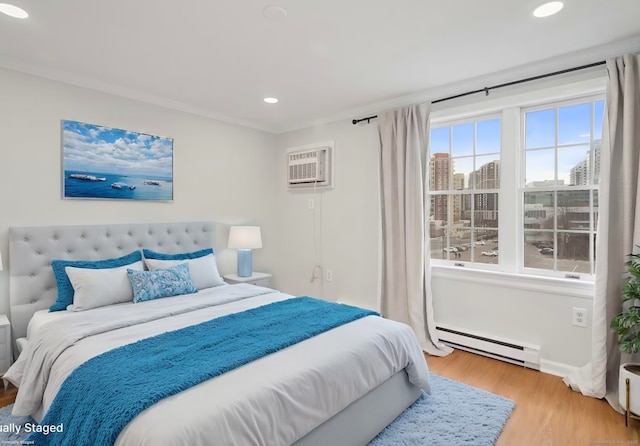 bedroom with crown molding, a baseboard radiator, wood-type flooring, and a wall mounted air conditioner