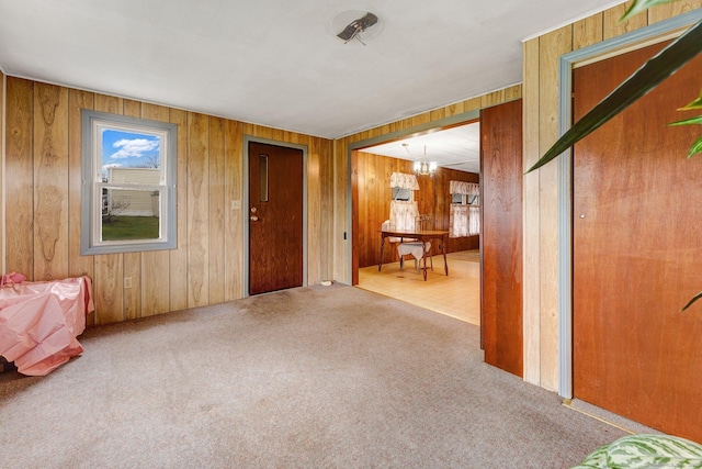 interior space featuring carpet floors and wooden walls