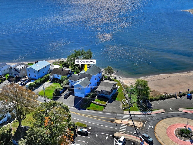 birds eye view of property with a water view and a view of the beach