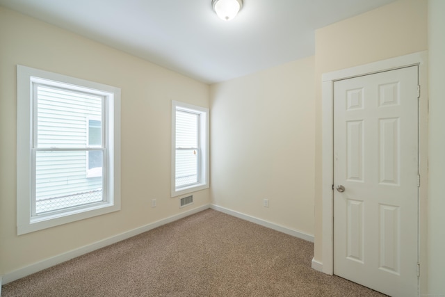 spare room with light colored carpet