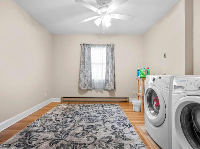 laundry area with baseboards, ceiling fan, light wood-style flooring, baseboard heating, and separate washer and dryer