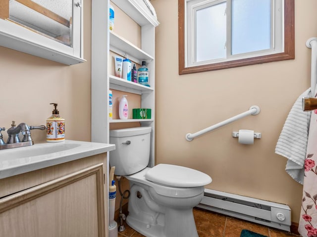 bathroom featuring toilet, vanity, baseboard heating, and tile patterned floors