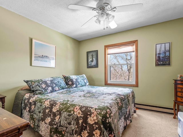 bedroom with light carpet, ceiling fan, baseboard heating, and a textured ceiling