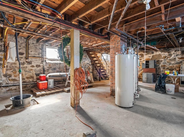 below grade area featuring stairway and gas water heater