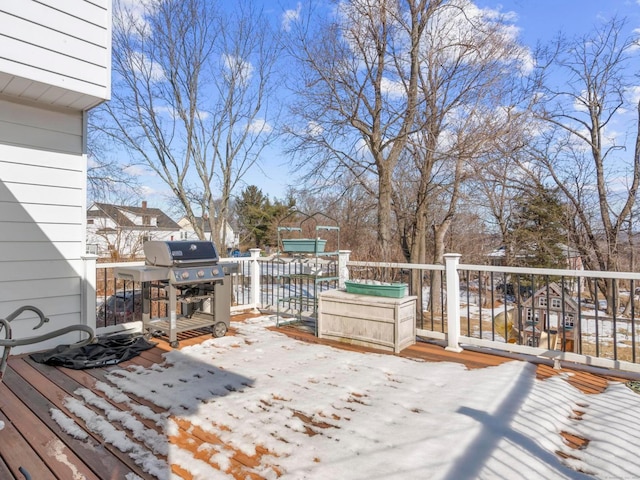 snow covered deck with a grill