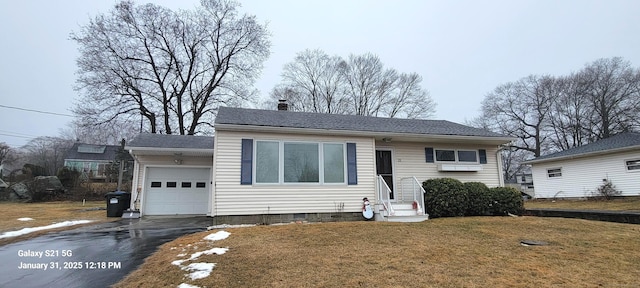 view of front of house with a garage and a front lawn