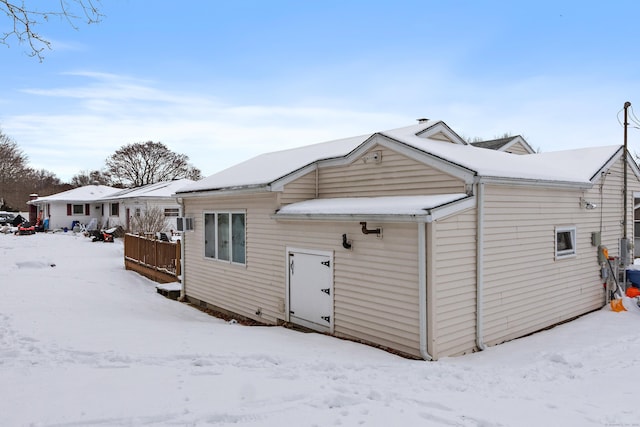 view of snow covered back of property