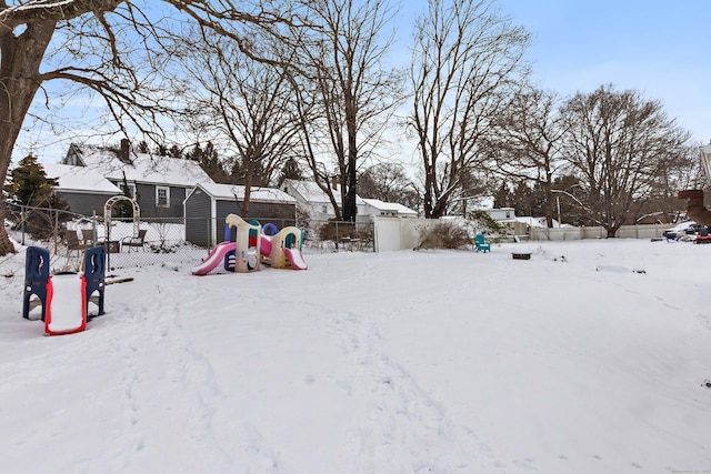 snowy yard with a playground