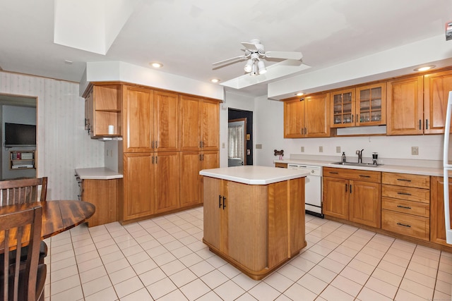 kitchen with dishwasher, sink, a center island, light tile patterned floors, and ceiling fan