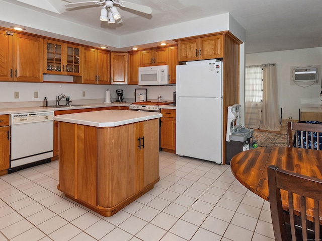 kitchen with light tile patterned flooring, sink, a center island, ceiling fan, and white appliances