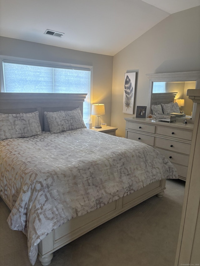 carpeted bedroom with vaulted ceiling