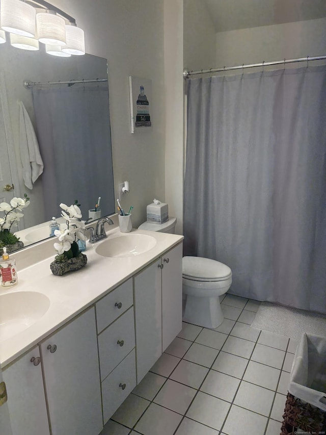 bathroom featuring tile patterned floors, toilet, and vanity